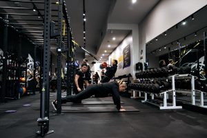 Trainer supervises plank fitness session